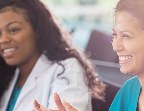 Professional development Q&A with Health care workers smile in a classroom setting