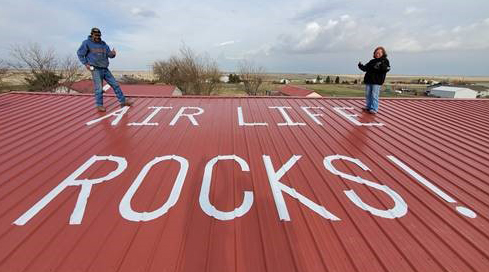 "Air Life Rocks!" printed on a barn roof near Denver