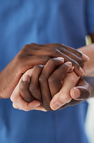 Closeup shot of a medical practitioner holding a patient's hand in comfort