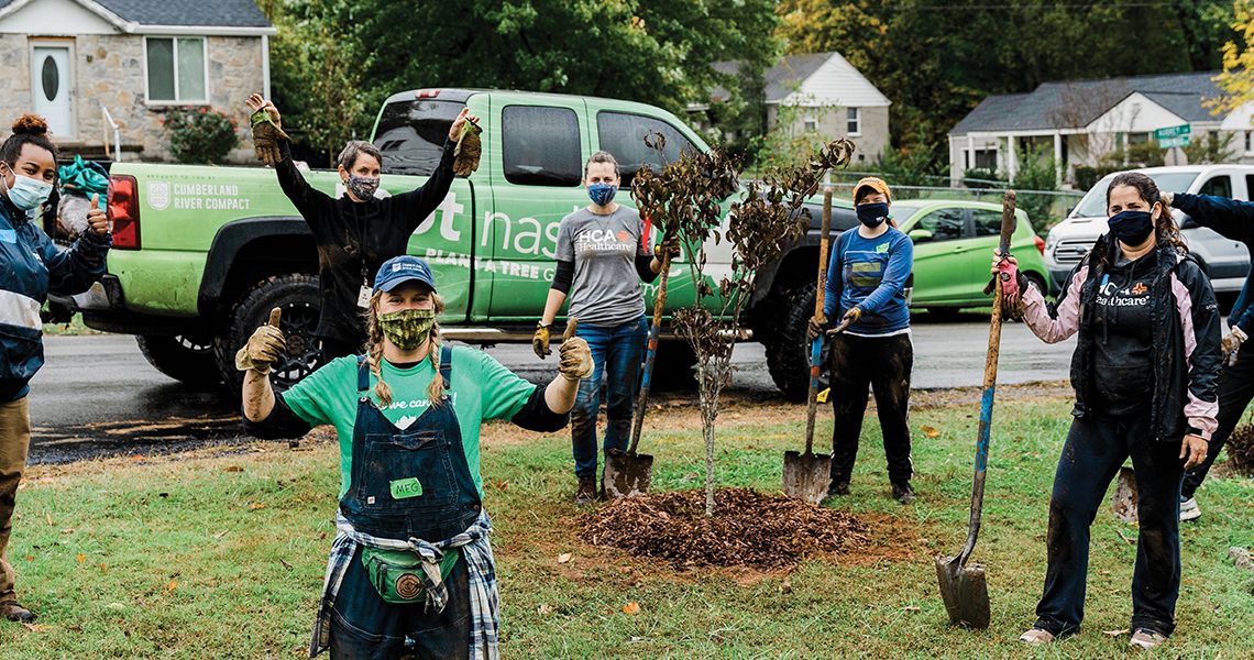 Colleagues with Nashville-based Physician Services Group give back at a tree-planting volunteer project.