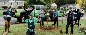 Colleagues with Nashville-based Physician Services Group give back at a tree-planting volunteer project.