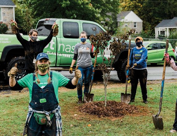 Colleagues with Nashville-based Physician Services Group give back at a tree-planting volunteer project.