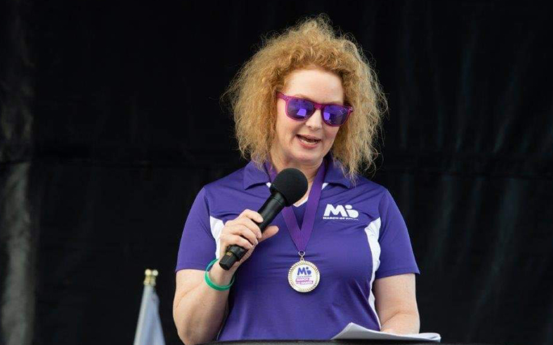 Person wearing a March of Dimes shirt giving a speech at a March for Babies event